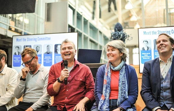 Some participants of the Denim Deal event laugh about something that is said.